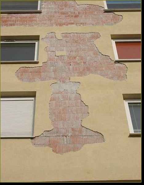 Efekt braku paroprzepuszczalności tynku na elewacji nowego budynku