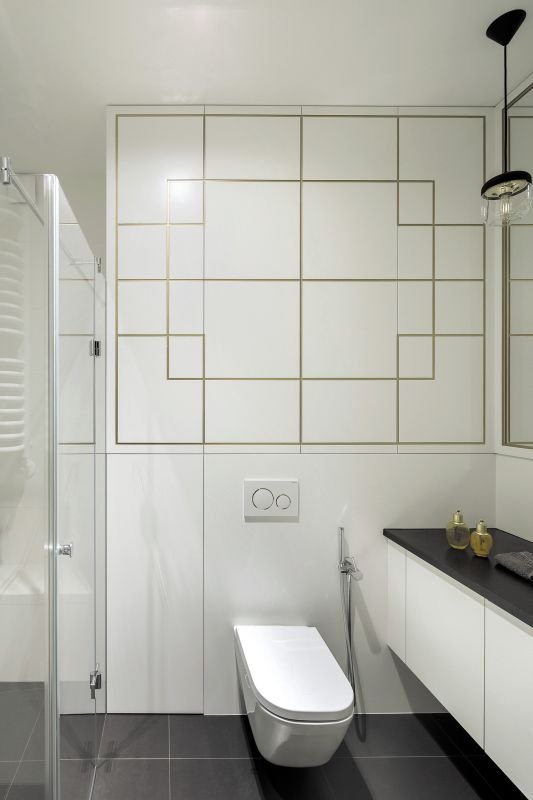 W zabudowie wnęki podwieszonego sedesu powstał pojemny schowek, który ma zalety nie tylko praktyczne, ale i estetyczne. Jego fronty ozdobiono bowiem motywem typowym dla stylu art deco, który narzucił zdecydowany charakter oszczędnemu wnętrzu.