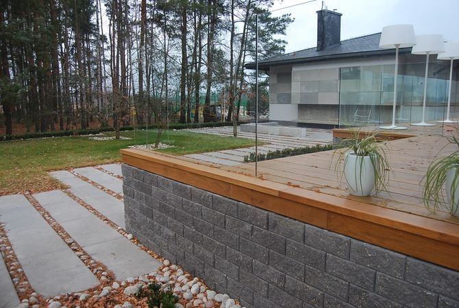 Betonowy murek współgra z architekturą budynku i wpisuje się w otoczenie