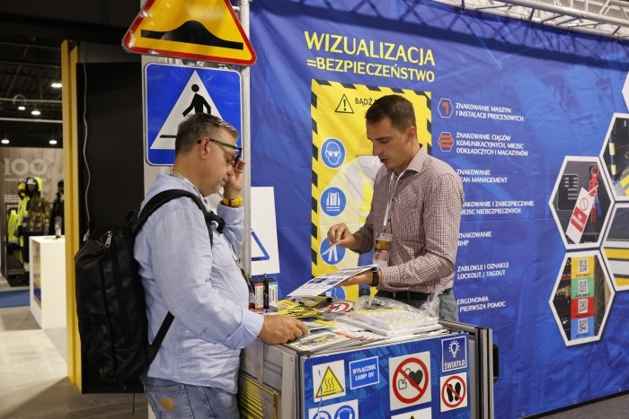 dwóch meżczyzn rozmawia na stoisku podczas targów